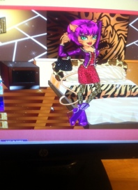 Here is Toralie Stripe in ghouls night out with her purple hair and purple leather jacket , black spider web leggings and red dress isn't  she a sight!